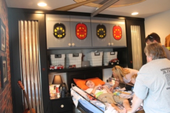 Connor being visited by friends and family. This is a nice view of the room decor, themed after a fire house. Dad is a fireman.